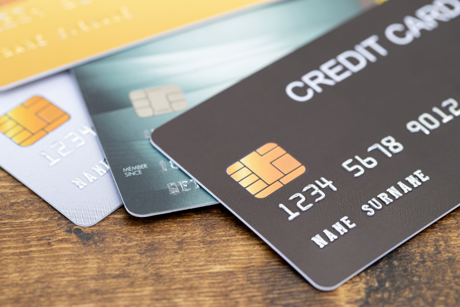 Close-up of multiple credit cards with visible EMV chips, representing credit cards, payments, and financial services.
