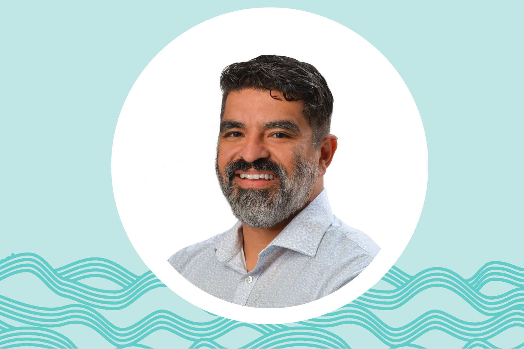 A professional portrait of a person with a beard wearing a light blue patterned button-down shirt, shown against a teal background with decorative wave graphics. The image features a circular photo frame and a clean, modern design.