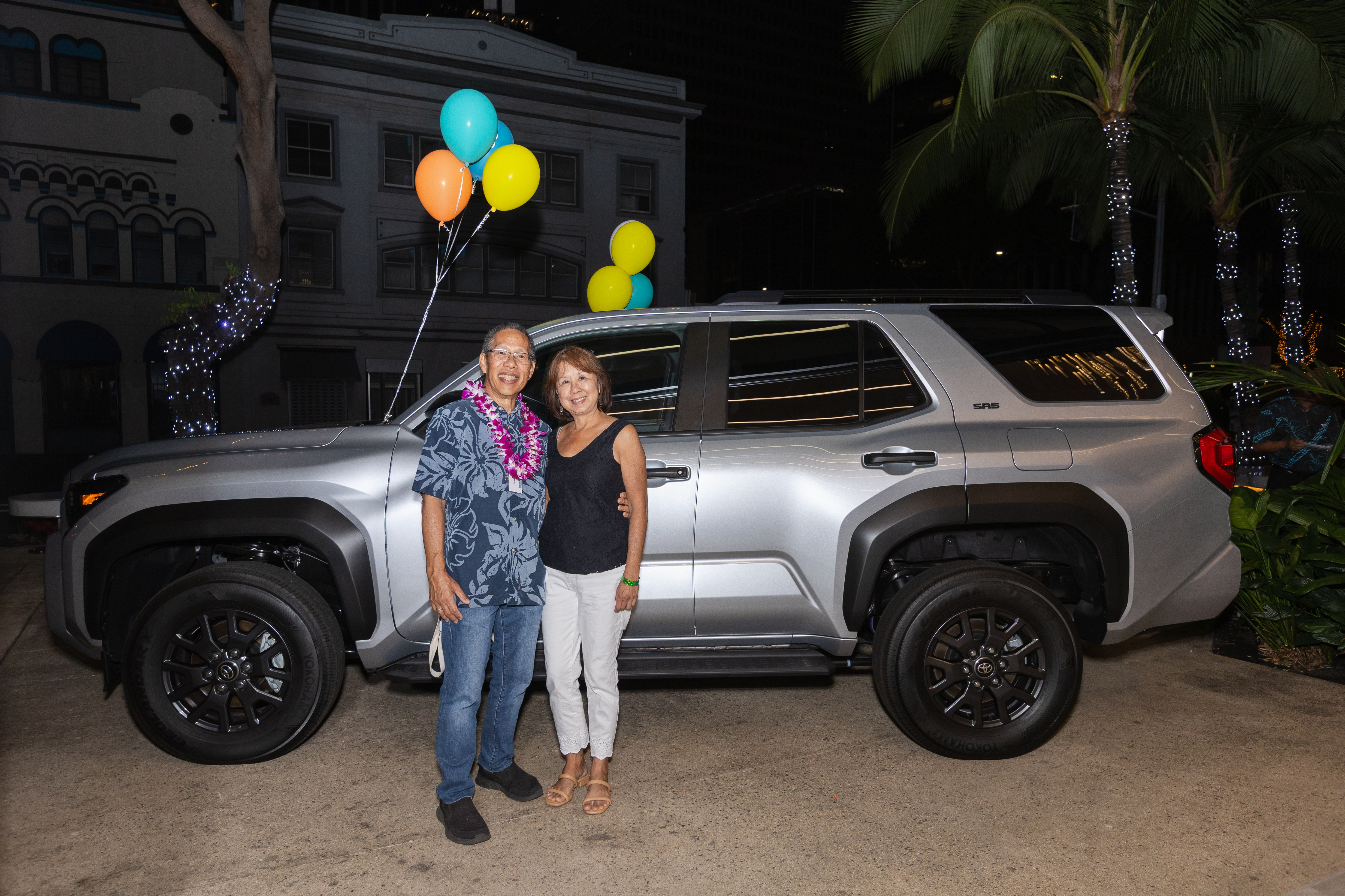 Grand prize winners stand in front of a new Toyota 4Runner during Central Pacific Bank’s customer appreciation prize giveaway event.
